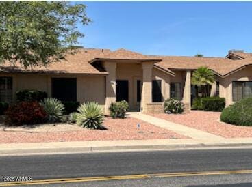 single story home featuring stucco siding