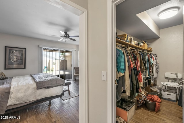 bedroom featuring wood finished floors, a closet, and access to outside