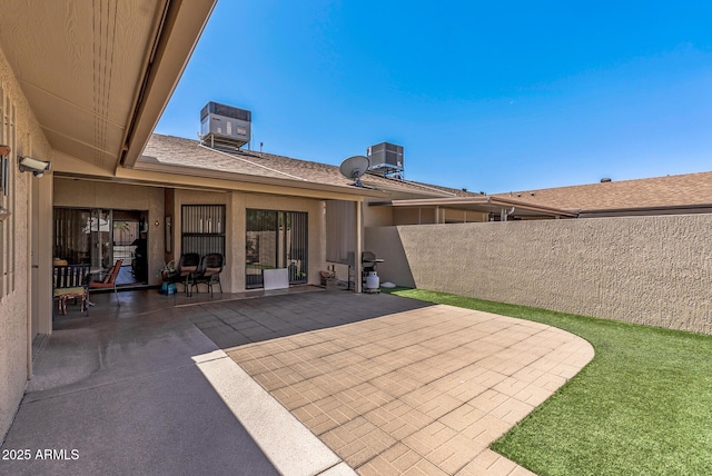 view of patio featuring fence and central AC unit
