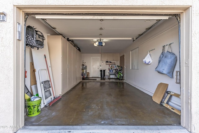 garage featuring water heater and a garage door opener