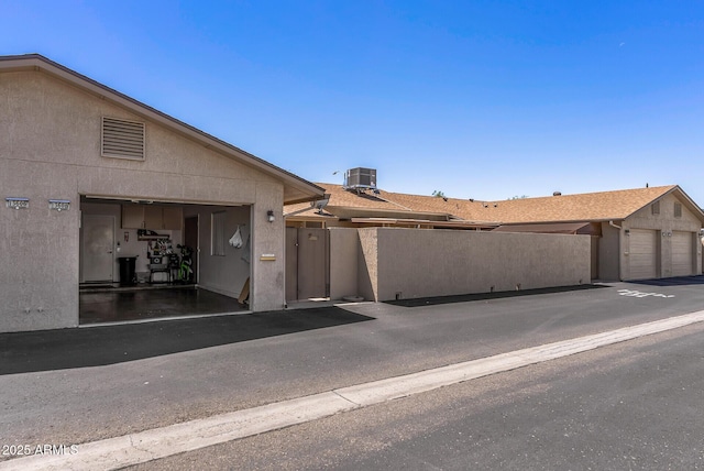 exterior space with central AC and stucco siding