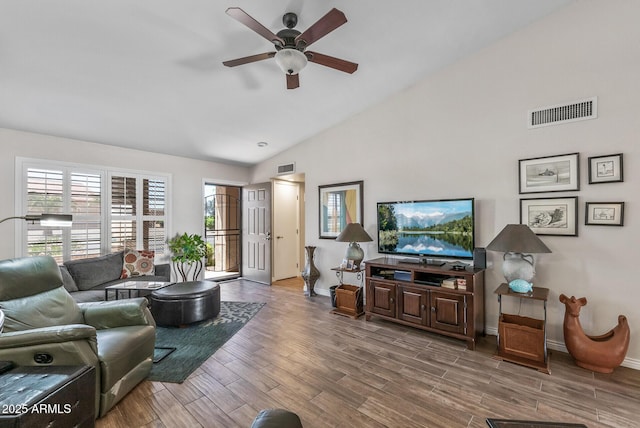 living room featuring wood finished floors, plenty of natural light, a ceiling fan, and visible vents