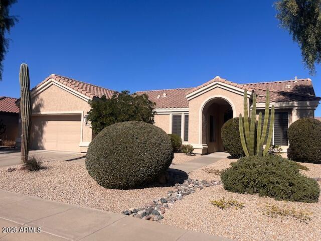 view of front facade featuring a garage and a pergola