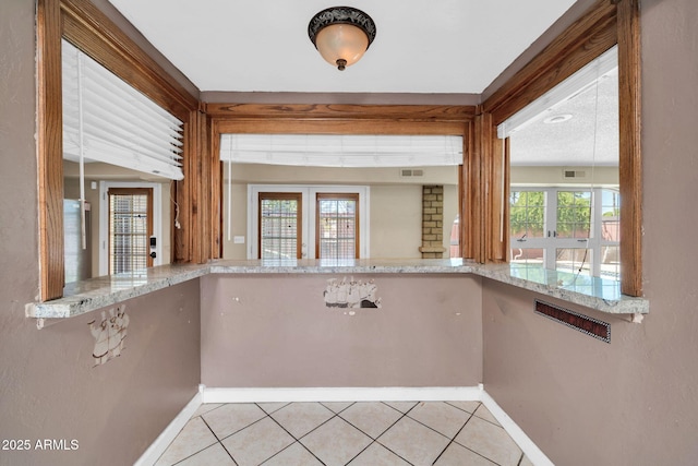 6217 W Orange Dr, Glendale, AZ 85301 - kitchen featuring tile patterned floors and light stone counters