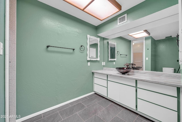 6217 W Orange Dr, Glendale, AZ 85301 - bathroom featuring vanity, a textured wall, and tile patterned floors