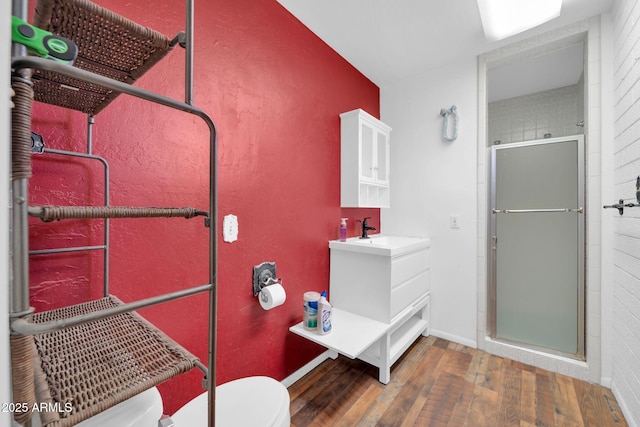 6217 W Orange Dr, Glendale, AZ 85301 - full bathroom with wood-type flooring, a shower stall, and vanity