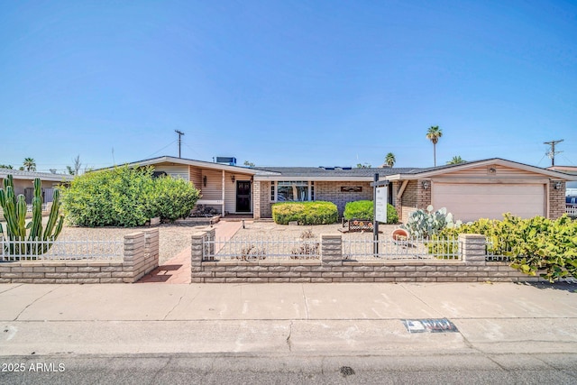 6217 W Orange Dr, Glendale, AZ 85301 - mid-century modern home featuring a fenced front yard, a garage, and brick siding