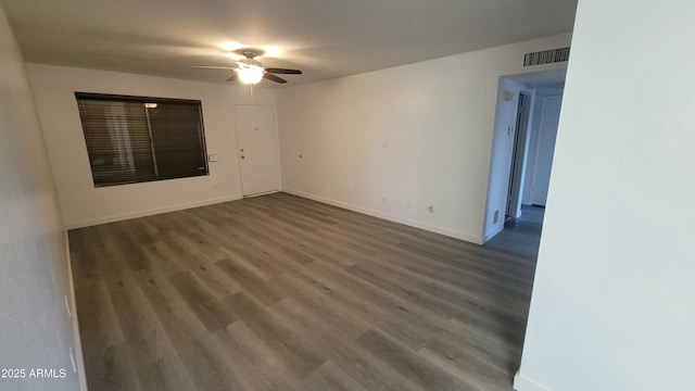 spare room featuring ceiling fan and dark hardwood / wood-style flooring