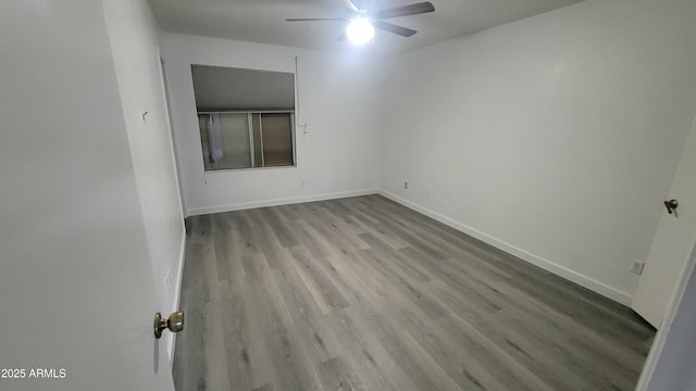 empty room featuring ceiling fan and light wood-type flooring