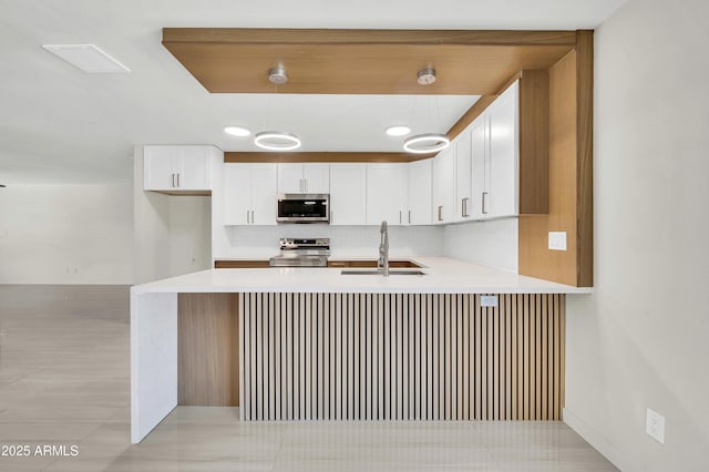 8146 N 17th Dr, Phoenix, AZ 85021 - kitchen with appliances with stainless steel finishes, a sink, a peninsula, and light countertops
