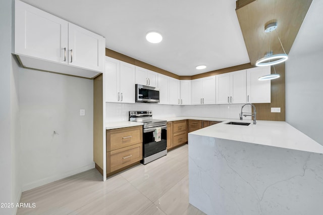 8146 N 17th Dr, Phoenix, AZ 85021 - kitchen with appliances with stainless steel finishes, a sink, a peninsula, and tasteful backsplash