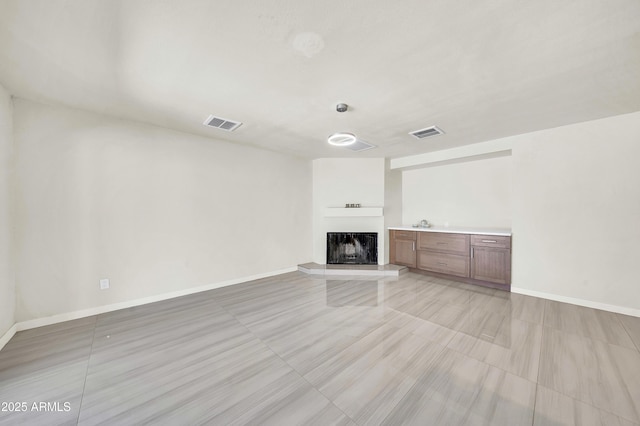 8146 N 17th Dr, Phoenix, AZ 85021 - unfurnished living room featuring baseboards and a fireplace with raised hearth