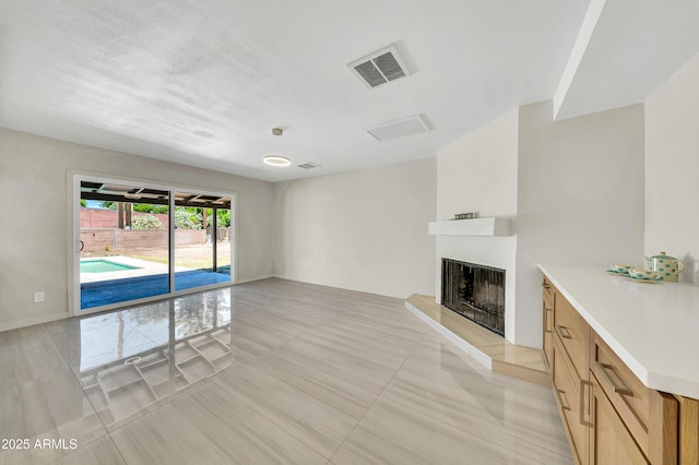 8146 N 17th Dr, Phoenix, AZ 85021 - unfurnished living room featuring a fireplace with raised hearth and light tile patterned floors