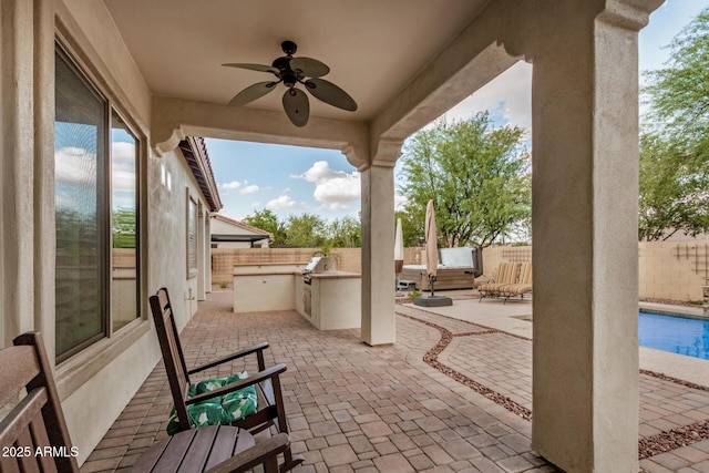 4453 S Huachuca Way, Chandler, AZ 85249 - fenced backyard with exterior kitchen, a ceiling fan, and a patio area