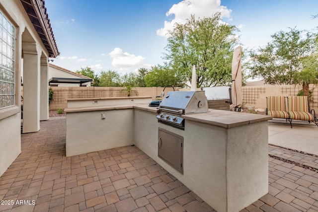 4453 S Huachuca Way, Chandler, AZ 85249 - fenced backyard with a patio area and exterior kitchen