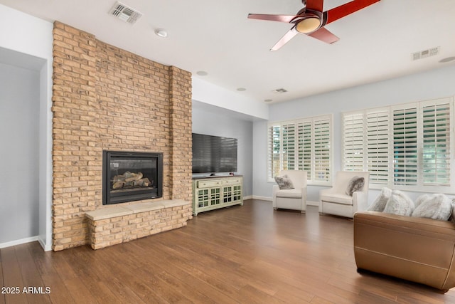 4453 S Huachuca Way, Chandler, AZ 85249 - living room with wood finished floors, ceiling fan, and a fireplace