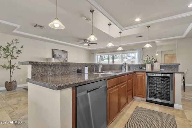 kitchen featuring stainless steel dishwasher, a raised ceiling, sink, pendant lighting, and wine cooler