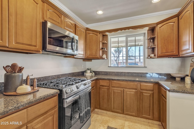 kitchen with light tile patterned floors, stainless steel appliances, crown molding, and dark stone countertops