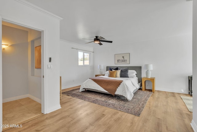 bedroom featuring light hardwood / wood-style floors, ceiling fan, and ornamental molding