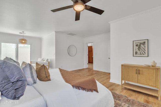 bedroom featuring ceiling fan, ornamental molding, and light hardwood / wood-style flooring