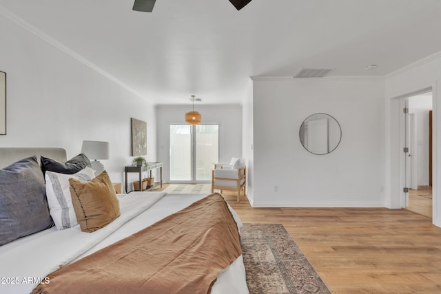 bedroom featuring ceiling fan, light hardwood / wood-style flooring, and crown molding