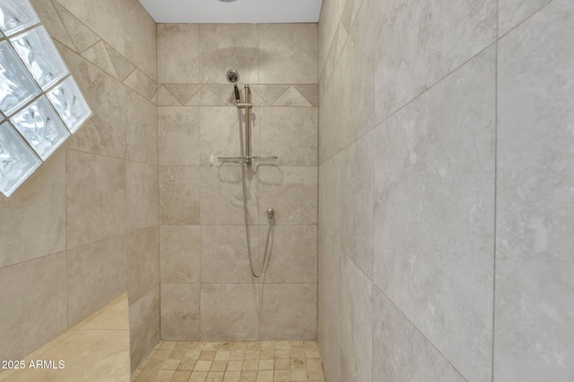 bathroom with a tile shower