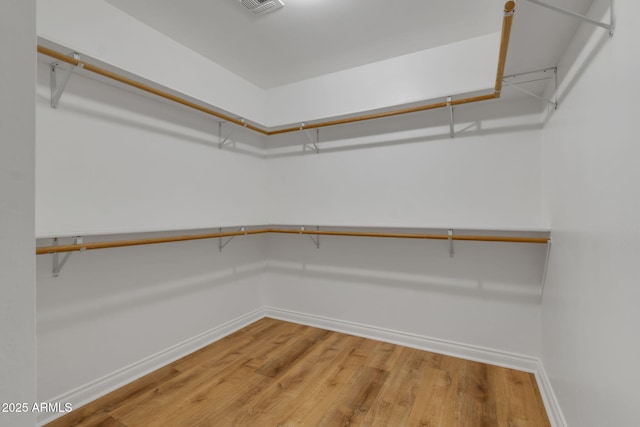 walk in closet featuring wood-type flooring