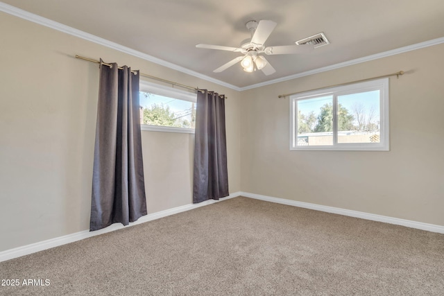 carpeted empty room featuring ceiling fan and crown molding