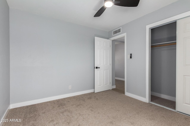 unfurnished bedroom featuring a closet, visible vents, baseboards, and carpet