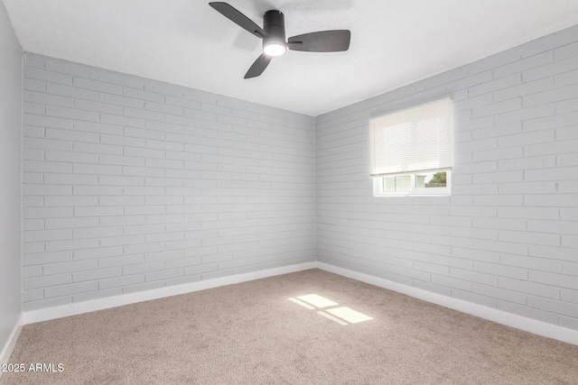 unfurnished room featuring carpet flooring, a ceiling fan, and baseboards