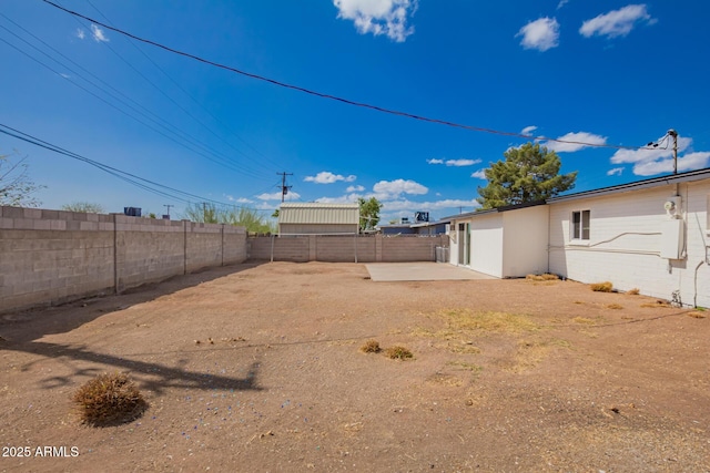view of yard featuring a patio and a fenced backyard