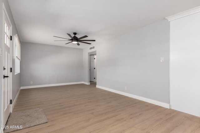 empty room with visible vents, baseboards, light wood-style floors, and a ceiling fan
