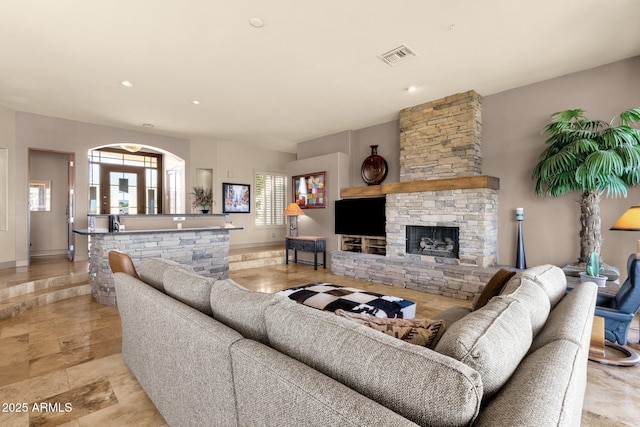living area with visible vents and a fireplace