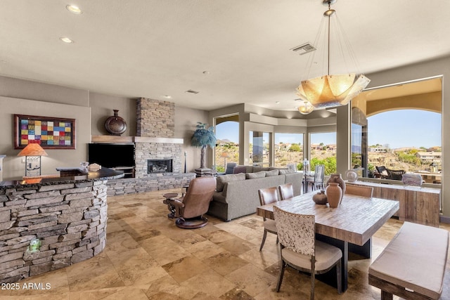 dining area featuring recessed lighting, visible vents, and a fireplace