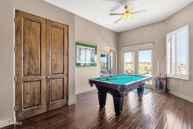playroom with dark wood-type flooring, ceiling fan, pool table, and arched walkways
