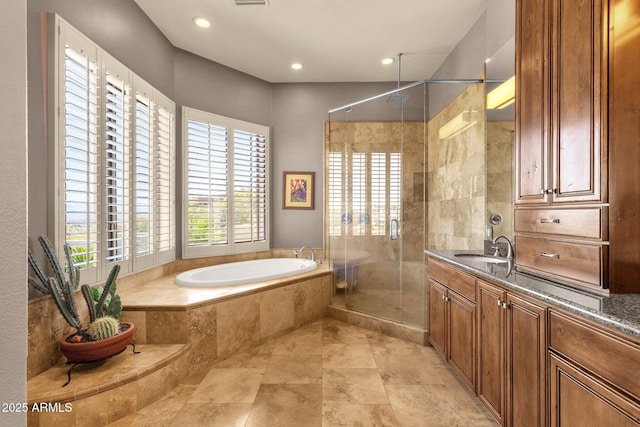 bathroom with recessed lighting, a stall shower, a bath, and vanity