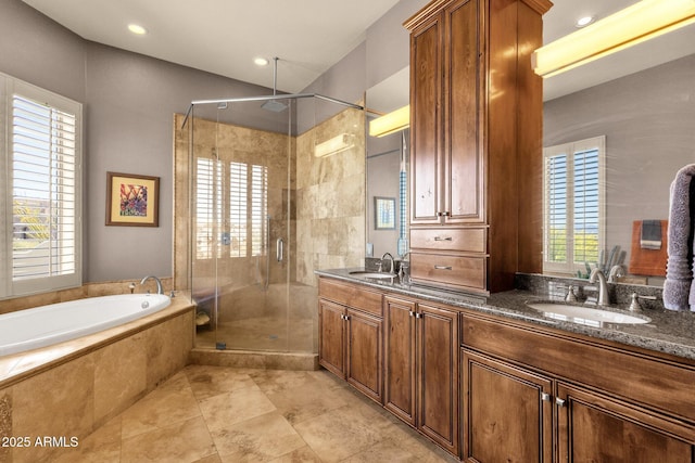bathroom with a sink, a shower stall, and a healthy amount of sunlight