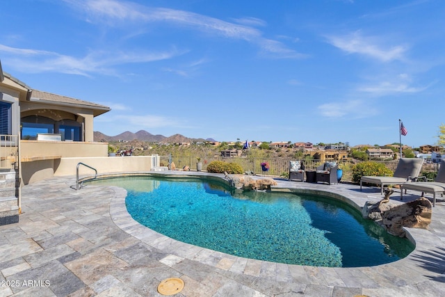 view of pool with a patio, a mountain view, and a fenced in pool
