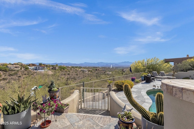 balcony with a patio area and a mountain view
