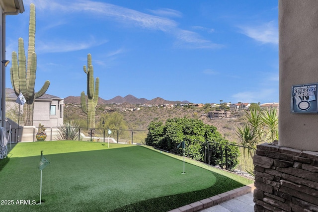 view of yard with fence and a mountain view