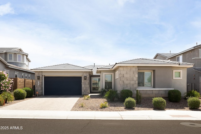 22421 N 34th St, Phoenix, AZ 85050 - prairie-style home featuring stone siding, a tile roof, driveway, and a garage
