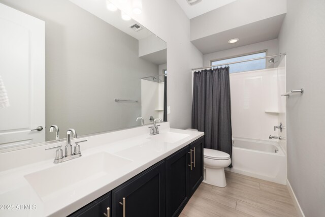 22421 N 34th St, Phoenix, AZ 85050 - bathroom with shower / tub combo with curtain, visible vents, a sink, and toilet