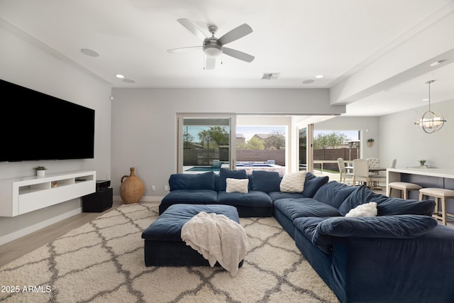 22421 N 34th St, Phoenix, AZ 85050 - living area with visible vents, baseboards, wood finished floors, recessed lighting, and ceiling fan with notable chandelier