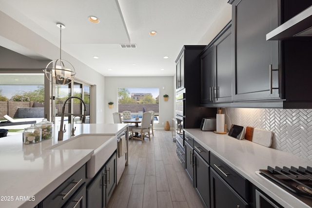 22421 N 34th St, Phoenix, AZ 85050 - kitchen with stainless steel gas stovetop, extractor fan, light countertops, and visible vents