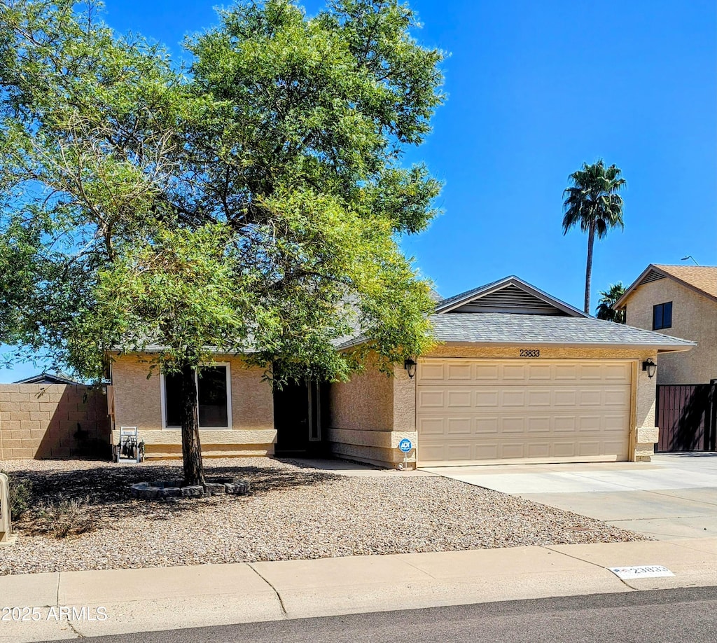 23833 N 39th Ln N, Glendale, AZ 85310 - ranch-style home featuring a garage, fence, concrete driveway, and stucco siding