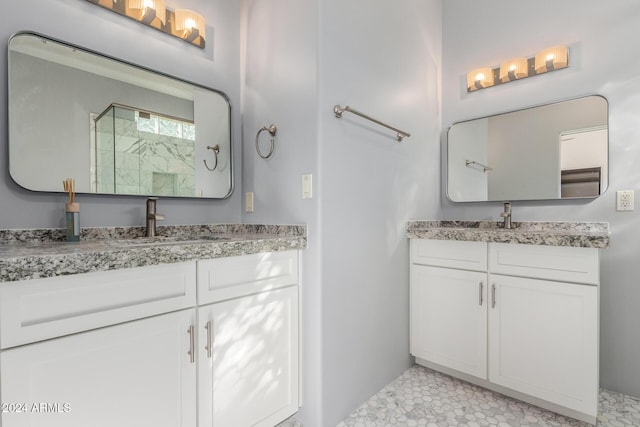 bathroom with tile patterned flooring, vanity, and walk in shower