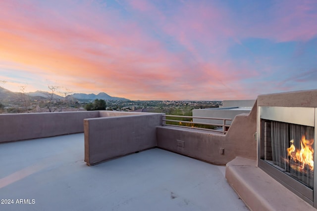 patio terrace at dusk featuring a mountain view