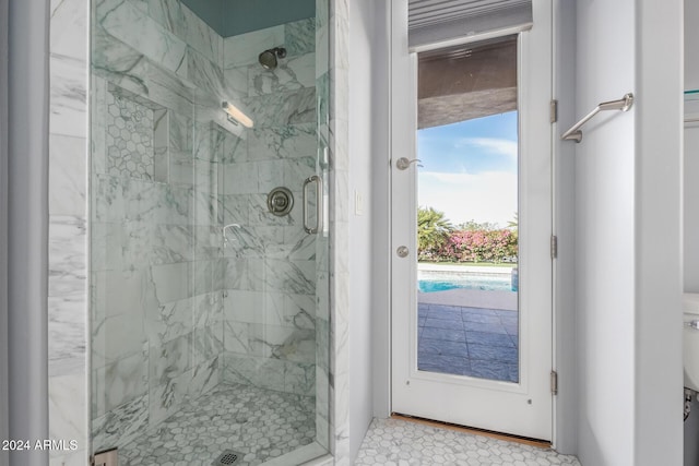 bathroom featuring a shower with door