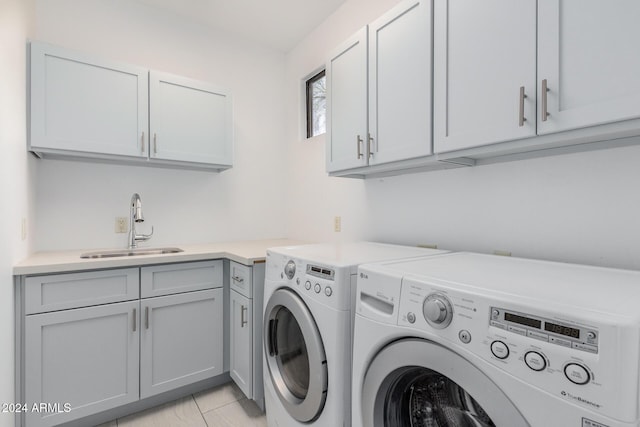 laundry room with washer and dryer, cabinets, light tile patterned floors, and sink