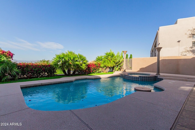 view of swimming pool with a patio area and an in ground hot tub